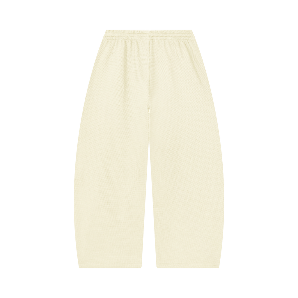 MIROLYUB Tessera waffle barrel pants in Mild Apricot, back view.