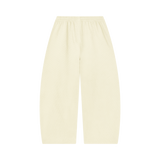 MIROLYUB Tessera waffle barrel pants in Mild Apricot, back view.
