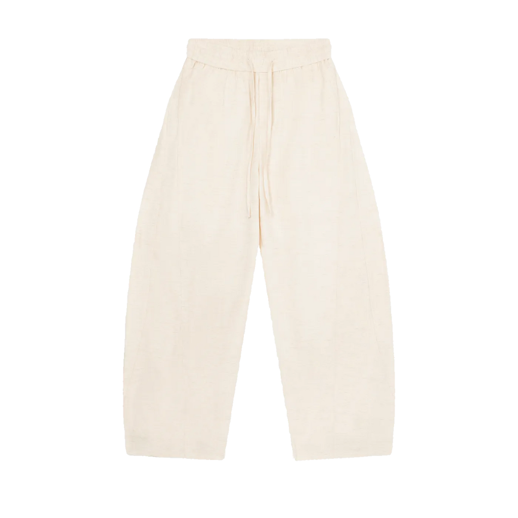 MIROLYUB Drift pants in Mild Apricot, front view with wide legs, tonal panels and a drawstring waist
