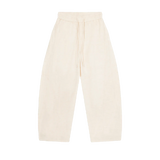 MIROLYUB Drift pants in Mild Apricot, front view with wide legs, tonal panels and a drawstring waist