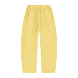 MIROLYUB Arc Vintage-Wash Barrel Fleece Pants in Light Yellow, front view.