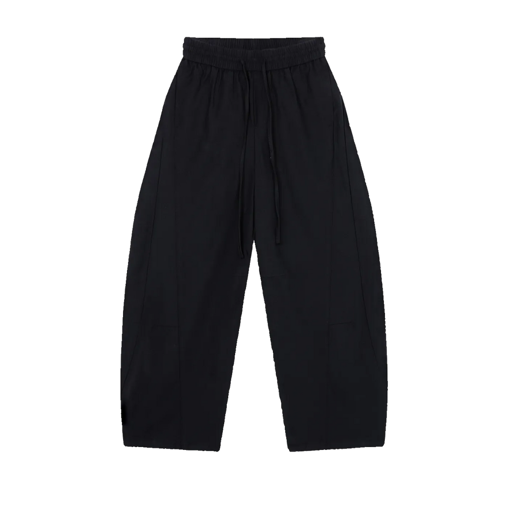 MIROLYUB Drift pants in Black, front view with wide legs, tonal panels and a drawstring waist