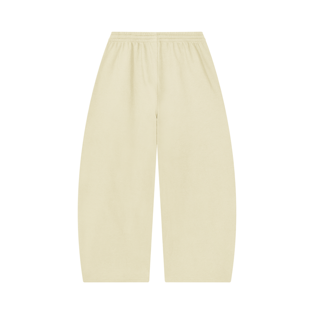 MIROLYUB Tessera waffle barrel pants in Apricot, back view.