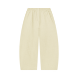 MIROLYUB Tessera waffle barrel pants in Apricot, back view.