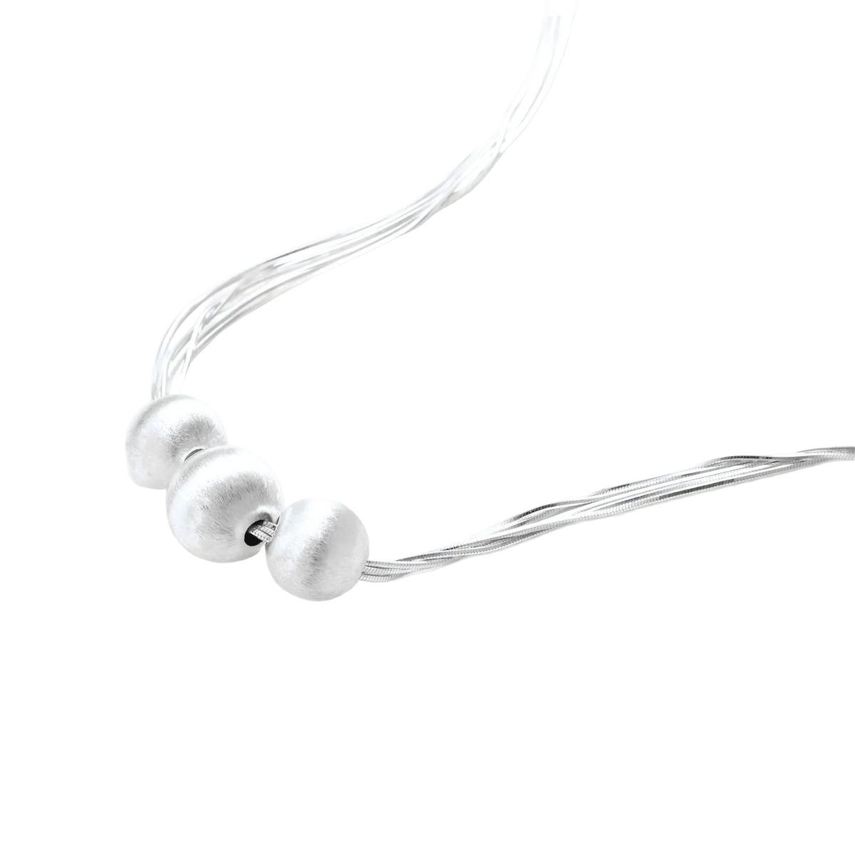 Angled detail of Borislav necklace showing three brushed sterling silver beads and polished chains