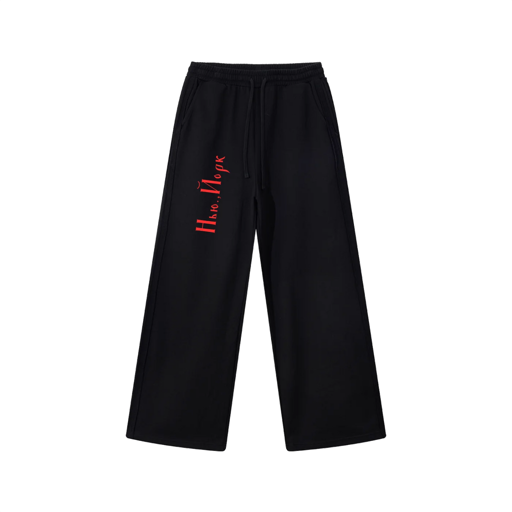 Front view of black straight-leg drawstring sweatpants with red Cyrillic New York lettering