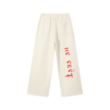 Back view of Mild Apricot straight-leg sweatpants with red Ne Yebyot Cyrillic lettering