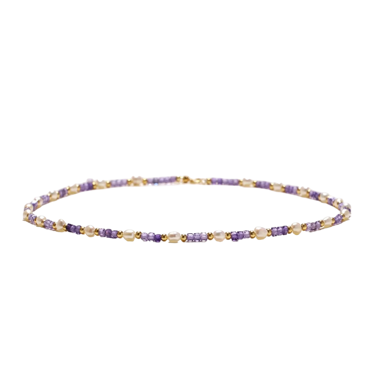 Low-angle view of Ljubica necklace with freshwater pearls, violet zirconia cubes and gold vermeil beads