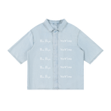 Front view of light blue lyocell shirt with white New York and inverted Pizdets lettering