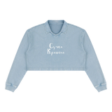 Front view of Gray Blue collared cropped sweatshirt with white Suchka Krashena Cyrillic lettering