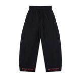 Black MIROLYUB wide-leg drawstring pants with red hem lettering, front view.