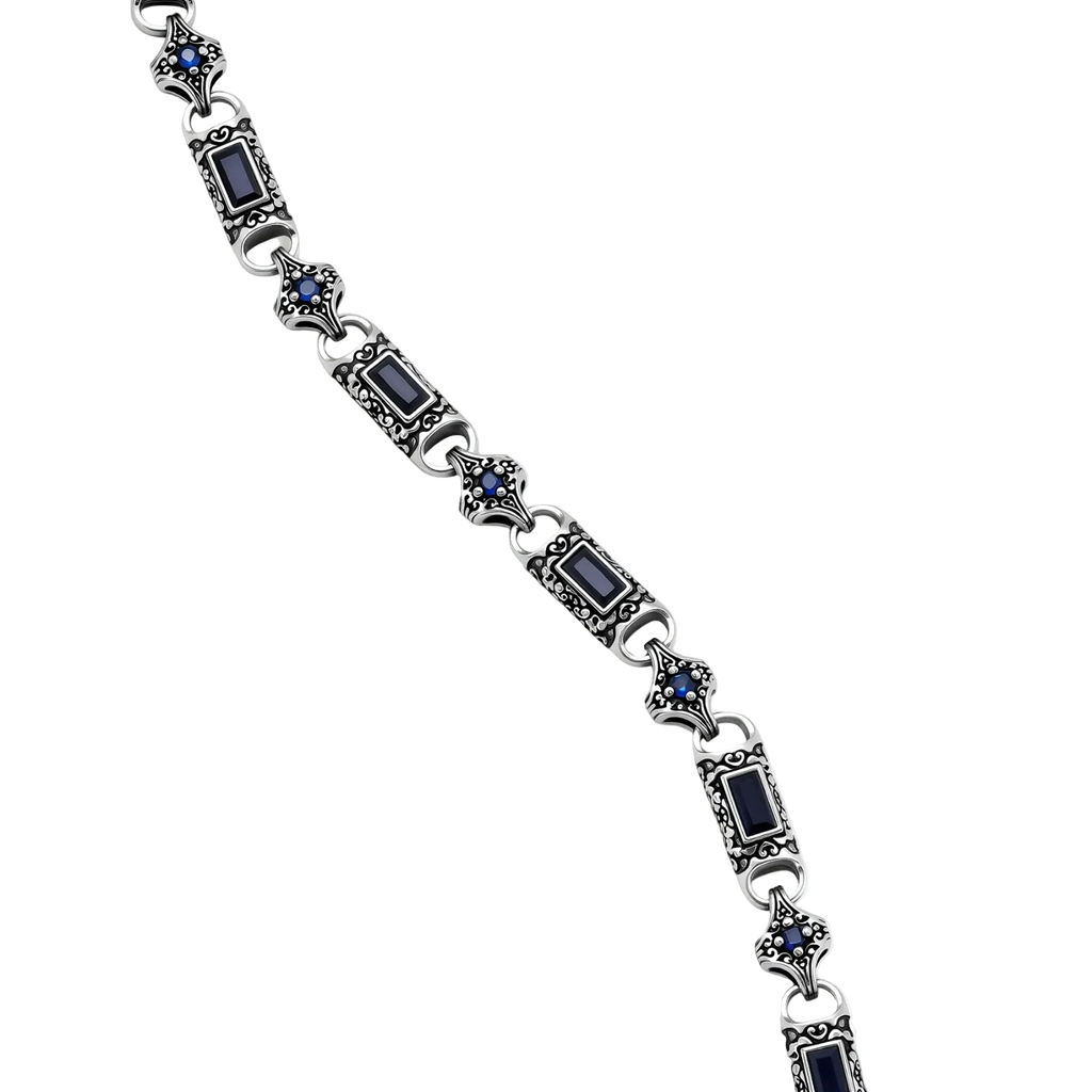 Close-up of Vladislav necklace showing dark blue cubic zirconia and engraved silver-plated links