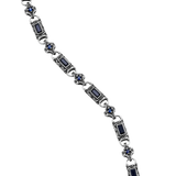 Close-up of Vladislav necklace showing dark blue cubic zirconia and engraved silver-plated links