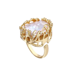 Angled view of Vladislava ring: iridescent baroque pearl in a gold-plated open cage with clear crystal flowers and an adjustable band
