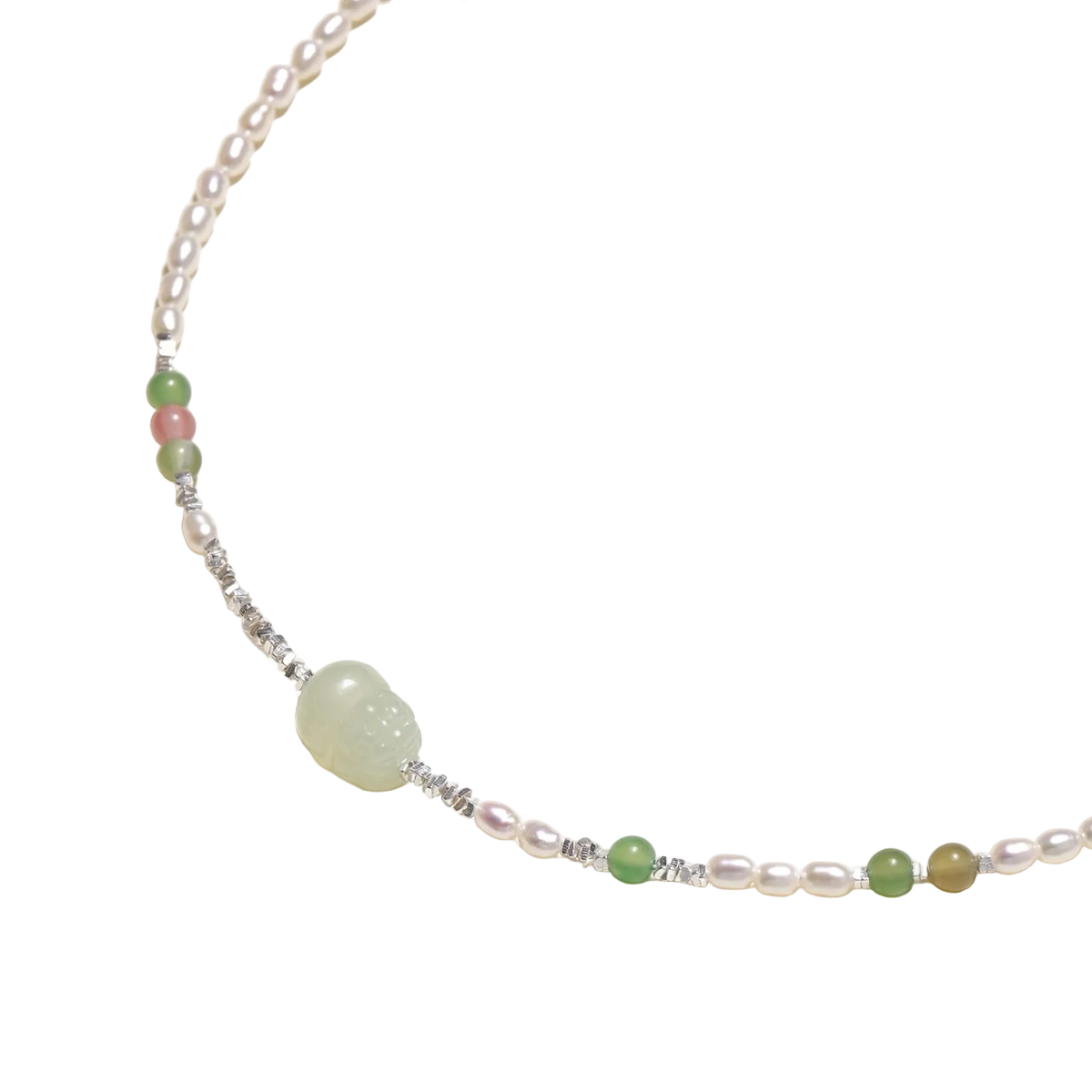 Angled detail of Zdravka necklace showing freshwater pearls, coloured stone beads and a pale green carved centre