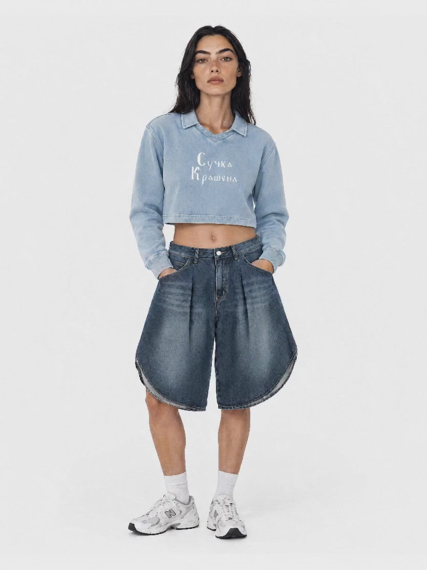 Neva wearing the gray-blue Suchka Krashena cropped sweatshirt and blue Ne Yebyot wide-leg denim shorts, rotating from front to back.